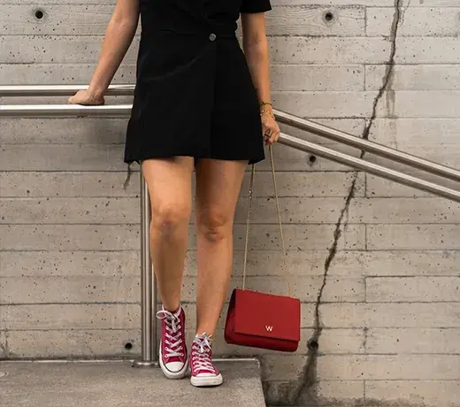 a black dress with colourful trainers